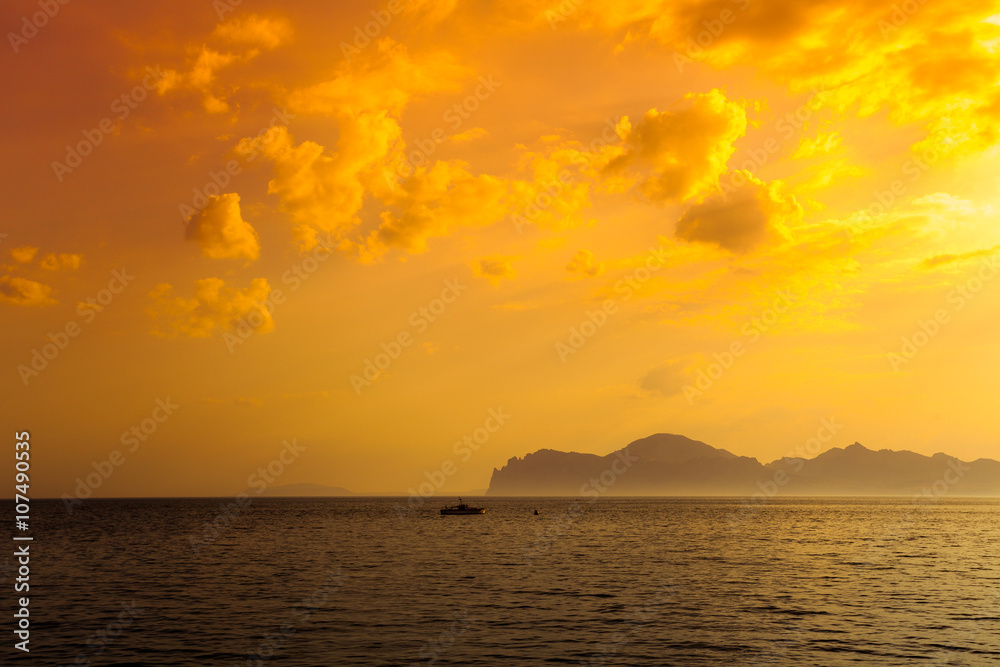 Beautiful golden sunset over rocky sea coast