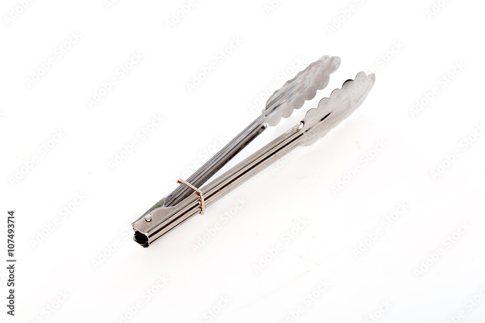 Serving kitchen tongs on white background, selective focus Serving kitchen tongs on white background, selective focus