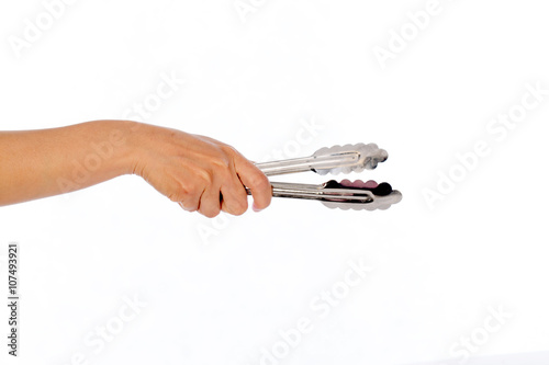 hand use tongs on white background, selective focus