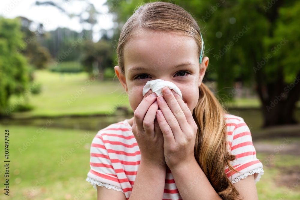 Sick girl sneezing in the park Sick girl sneezing in the park