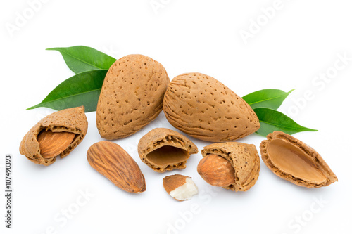 Almonds with leaves isolated on white background