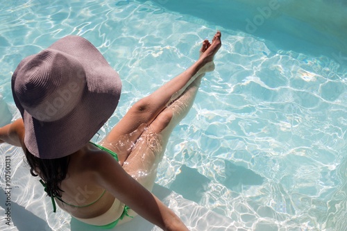 Woman enjoying sunbath in swimming pool