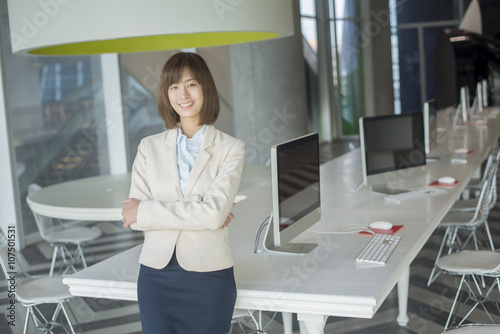 Attractive asian business woman smiling in workplace