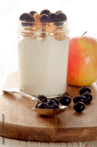 breakfast with yogurt, muesli, blueberries and apple