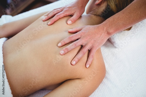 Woman receiving a back massage at spa
