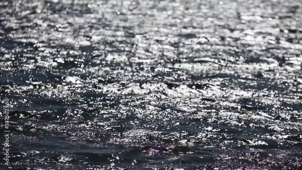 The water surface of the lake in the summer. Ripples on the water The water surface of the lake in the summer. Ripples on the water