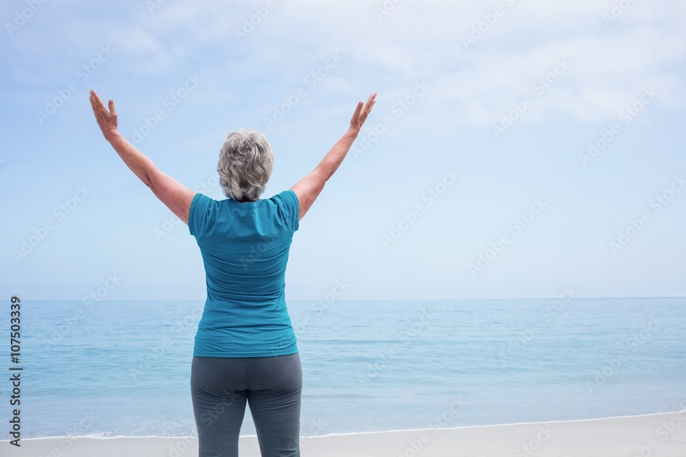Rear view of senior woman standing on the beach Rear view of senior woman standing on the beach