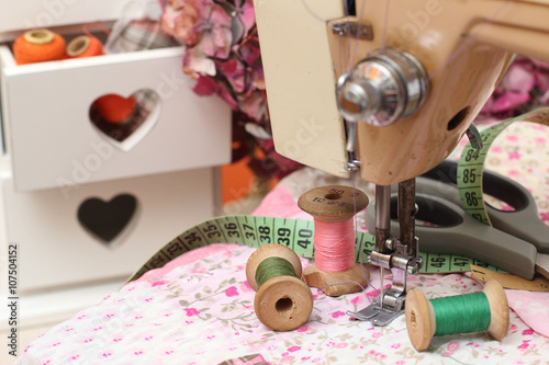 sewing machine, dressmaker scissors and thread-style retro photo