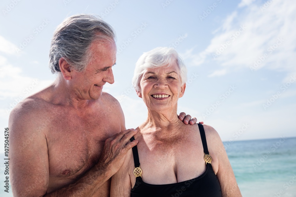 Senior couple embracing on beach