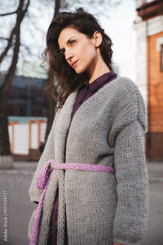 Woman wearing knitted colorful coat outdoor