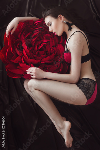 Fotografie Pretty girl in pink underwear with large paper flower
