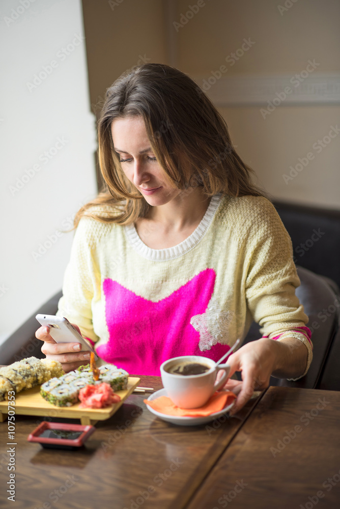 Young girl, sitting in a cafe with cup of coffee