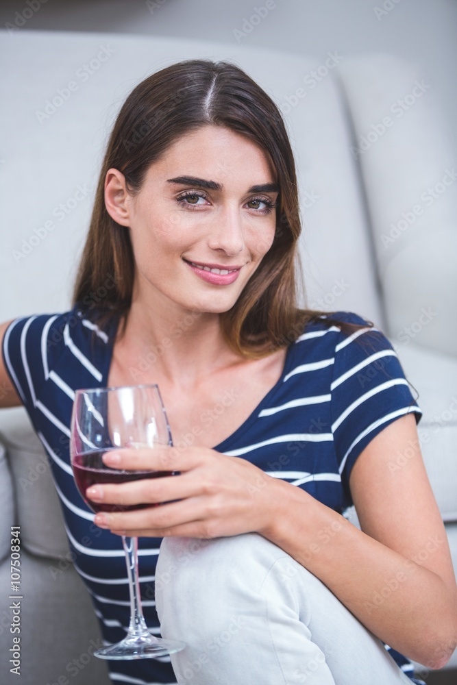 Beautiful woman sitting with a glass of red wine Beautiful woman sitting with a glass of red wine