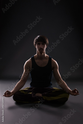 man doing yoga indoors