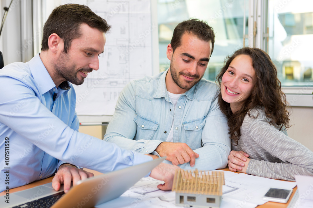 Fototapeta premium Young attractive people meeting real estate agent at the office