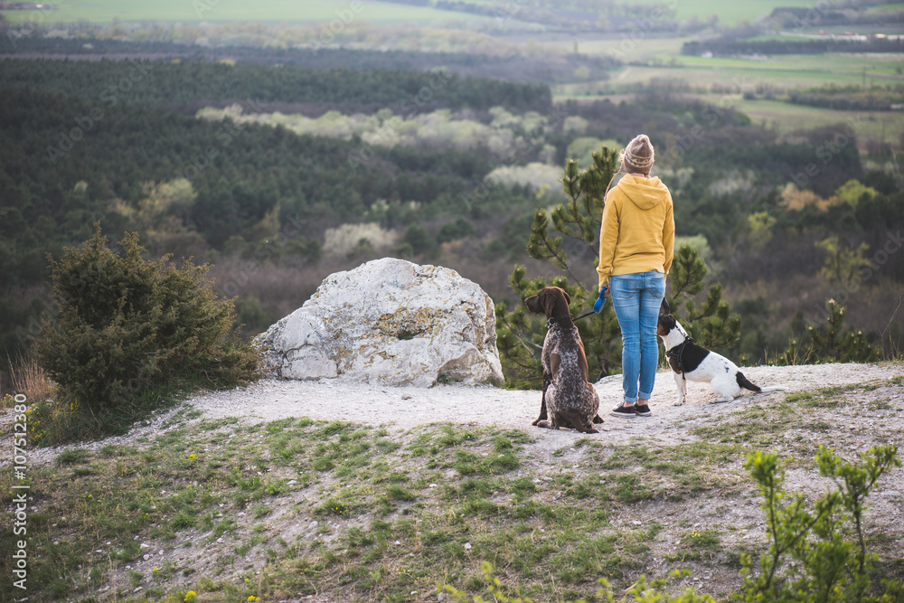 Woman and her dogs posing outdoor. 
