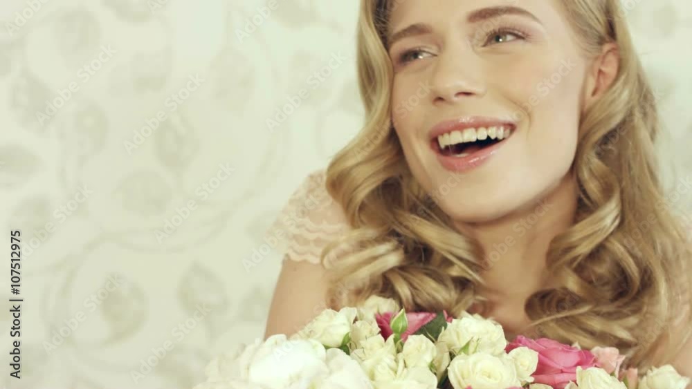 Enthusiastic girl posing with a big and beautiful bouquet of small roses Enthusiastic girl posing with a big and beautiful bouquet of small roses