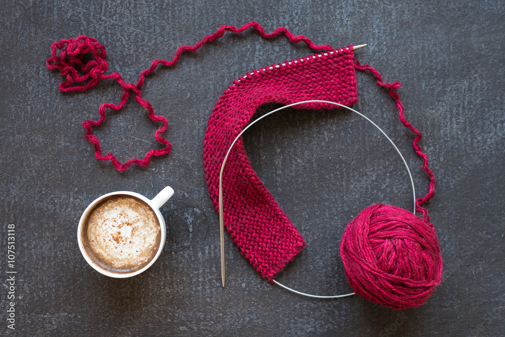 Red knitting and a cup of coffee Red knitting and a cup of coffee