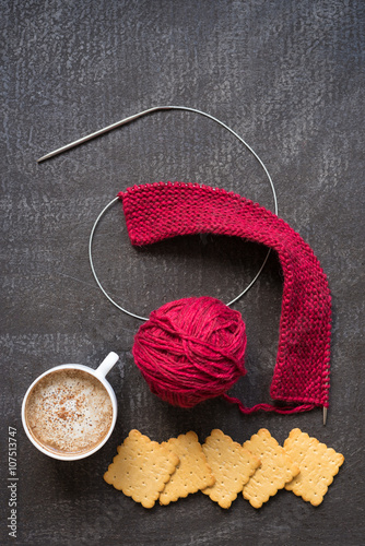 Bertical image of knitting, coffee and crackers photo