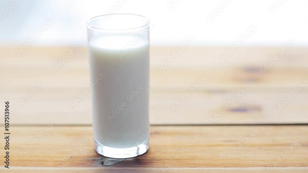 full glass of milk on wooden table full glass of milk on wooden table