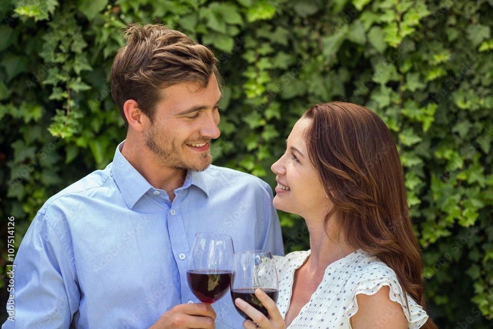 Romanic couple looking at eachother while holding wineglasses Romanic couple looking at eachother while holding wineglasses