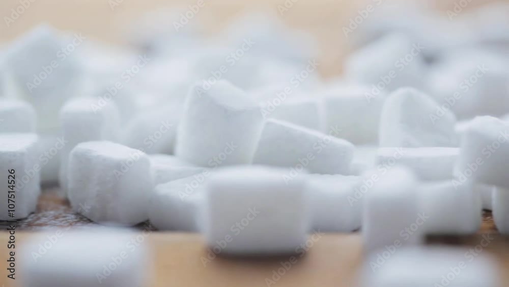 close up of white sugar on wooden board or table close up of white sugar on wooden board or table