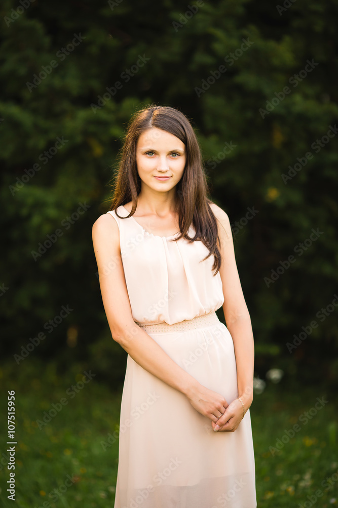 Young woman lovely smiling in a park and looking at camera