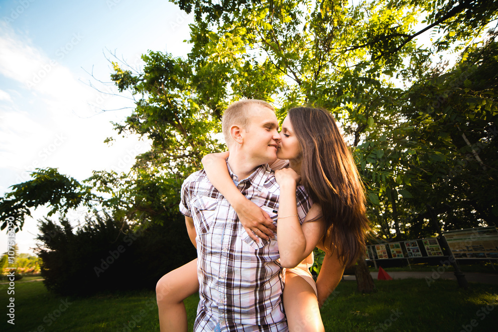 Fototapeta premium young teen couple in love having fun and enjoying the beautiful nature in park