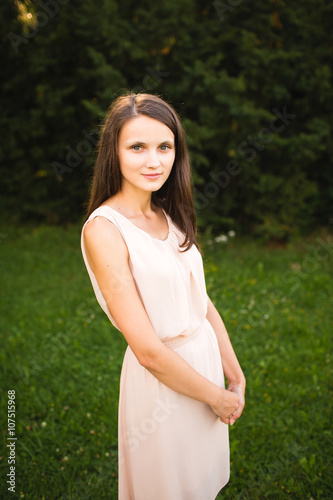 Young woman lovely smiling in a park and looking at camera