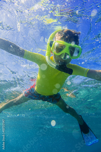 Boy dives in a tropical sea
