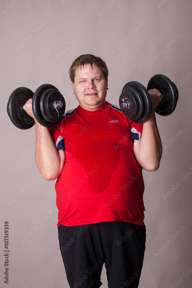fat man is involved with dumbbells fat man is involved with dumbbells