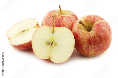 fresh sweet small apples and a cut one on a white background
