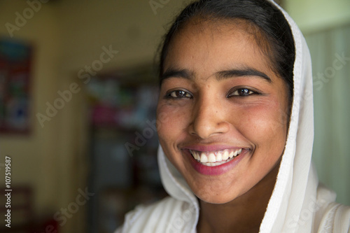 Close up of smiling girl wearing headscarf photo