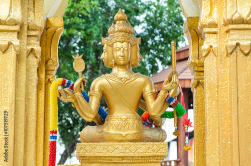 golden four face Buddha statue