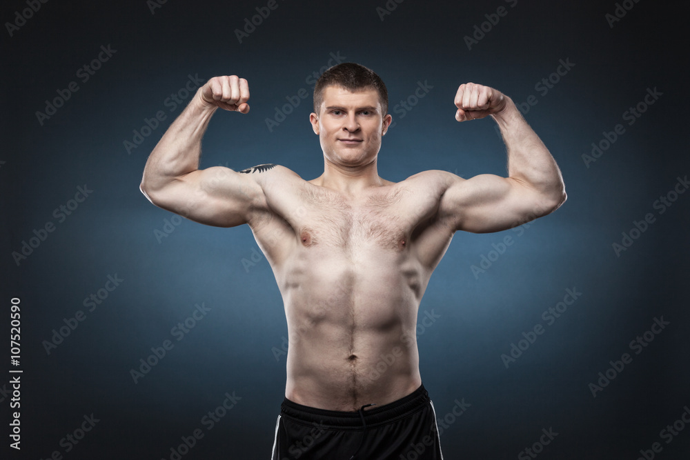 Sporty and healthy man isolated on dark blue background Sporty and healthy man isolated on dark blue background