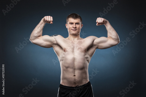 Sporty and healthy man isolated on dark blue background © Dmytro Panchenko