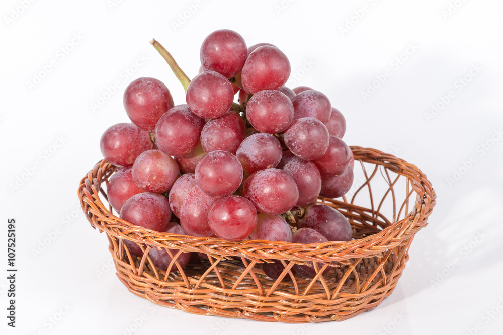 grapes in a basket isolated on white background grapes in a basket isolated on white background