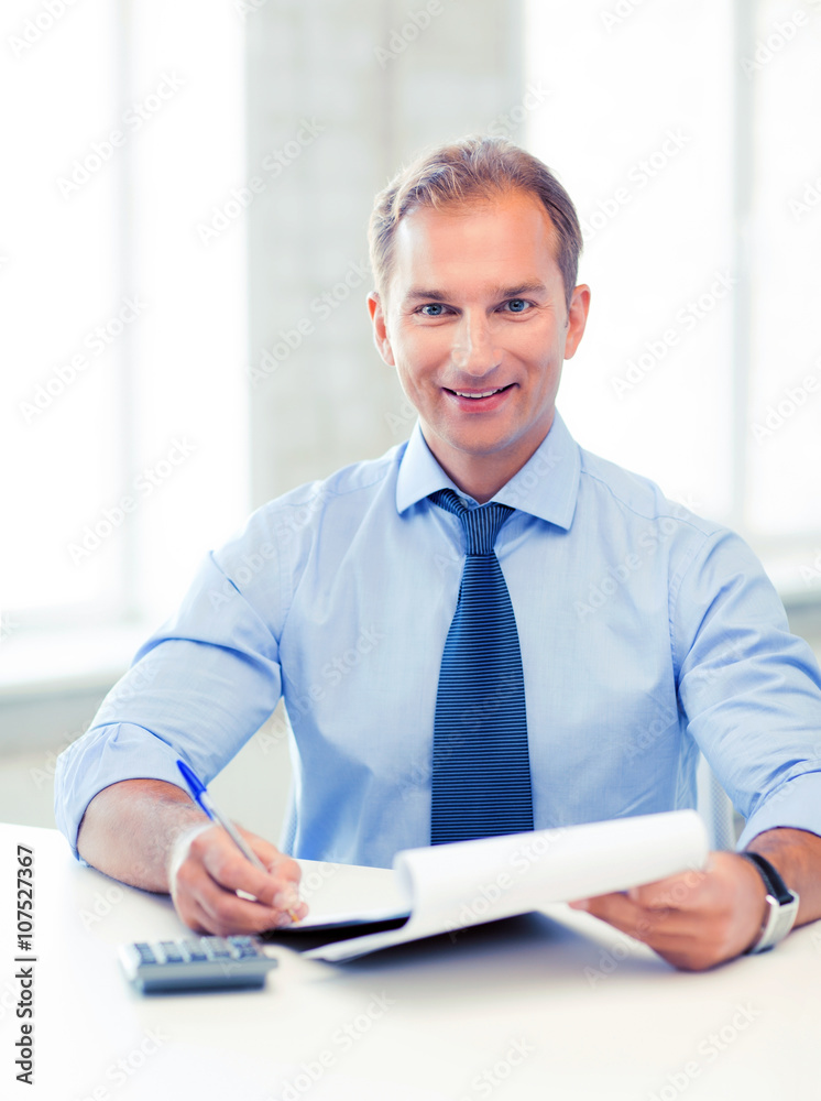 businessman with notebook and calculator businessman with notebook and calculator