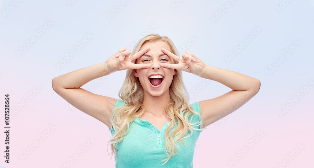 smiling young woman or teenage girl showing peace smiling young woman or teenage girl showing peace