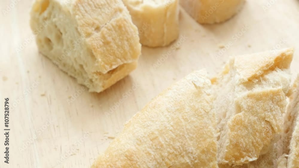 Baguette French bread on table smaller pieces cuts 4K 2160p 30fps UltraHD tilting footage - Slow tilt over traditional bread in France baguette 4K 3840X2160 UHD video Baguette French bread on table smaller pieces cuts 4K 2160p 30fps UltraHD tilting footage - Slow tilt over traditional bread in France baguette 4K 3840X2160 UHD video
