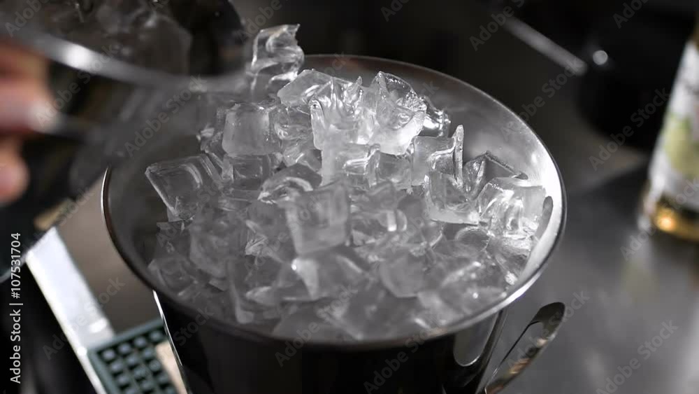 Metal ice bucket. Barman add ice. Metal ice bucket. Barman add ice.