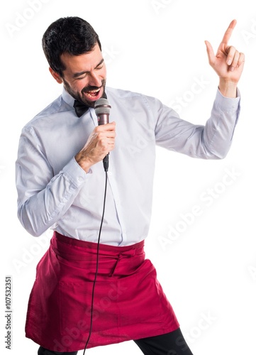 Foto Waiter singing with microphone