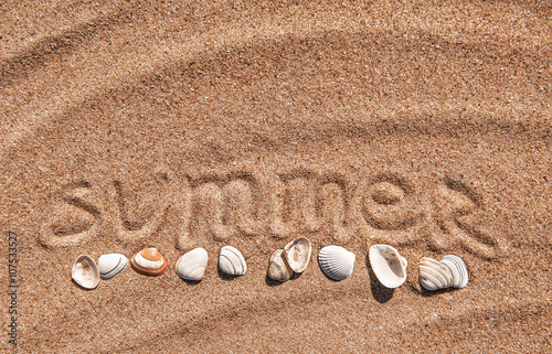 Summer background. Word summer and seashells on the sand