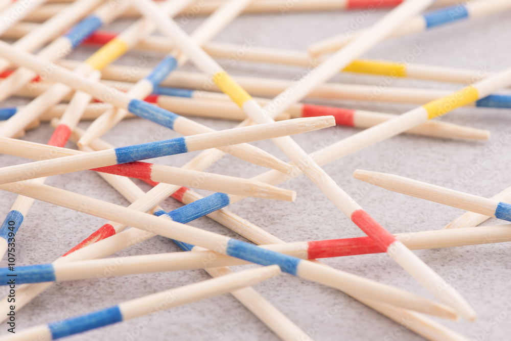 Mikado game wooden sticks on table. Concept of fun game with strategy, a real mess or chaos. Mikado game wooden sticks on table. Concept of fun game with strategy, a real mess or chaos.