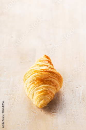 Croissant on wooden table