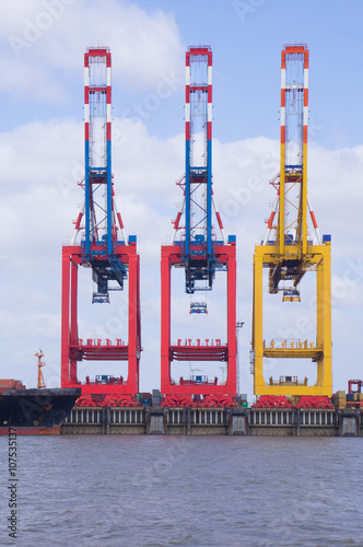 three loading cranes at the deep sea port of bremerhaven