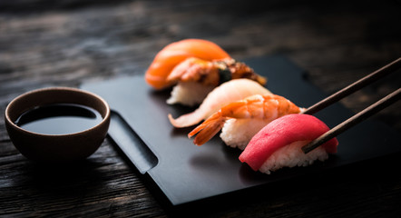 Gordijnen Sushi bar Sashimi set met stokjes en soja  © Ievgen Skrypko