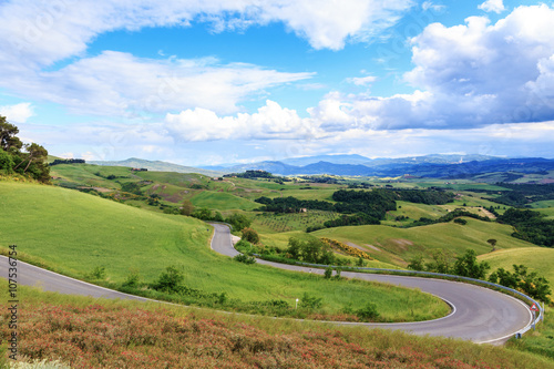 Road rural landscape of Tuscany and green rolling hills near Vol