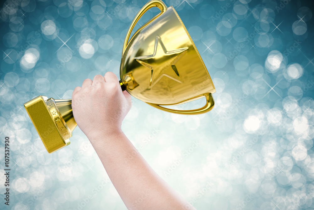 hand holding golden trophy with blue abstract background Stock Photo ...