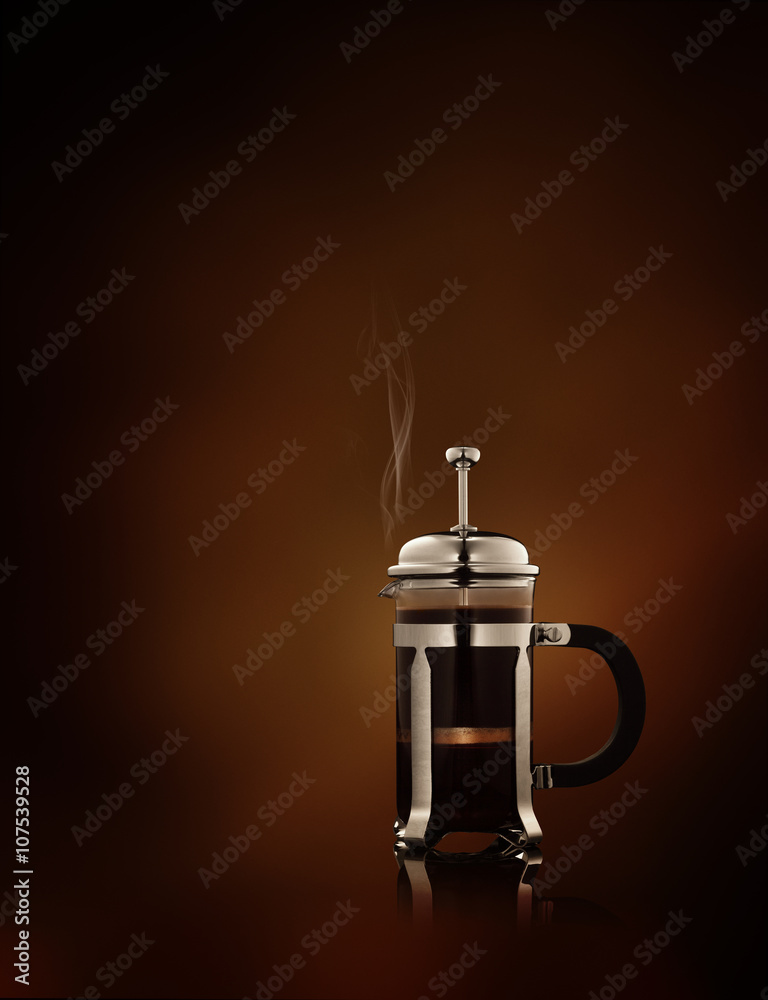 close up view of  french-press filled with fresh black coffee   on brown background